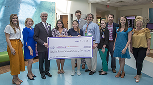 UWF's Dance Marathon executive board presents check to Pensacola's Studer Family Children's Hospital at Sacred Heart