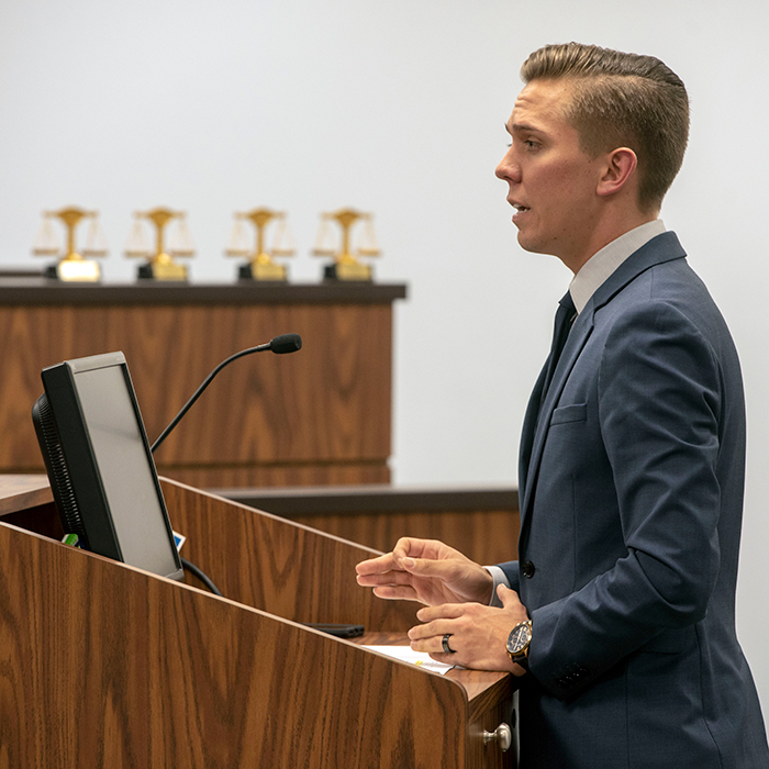 Student participating in a mock trial courtroom	