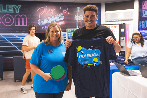 Student Posing with dean with I beat the dean tshirt