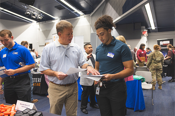 student meeting with recruiter during job fair