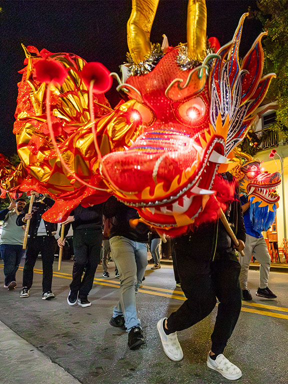 Students walking with dragon in Gallery Night for Lunar New Year