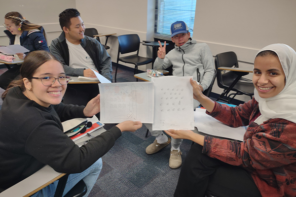 students posing with english papers