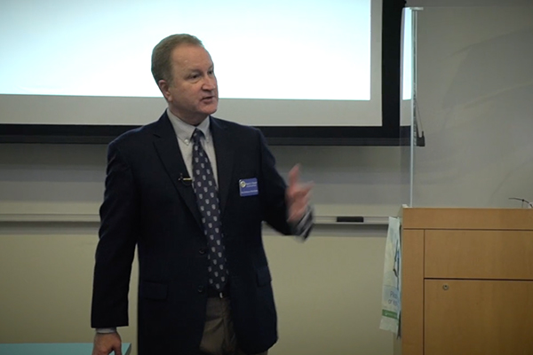 Greg Prescott speaks to a group at financial workshop