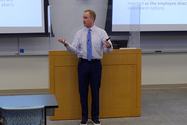 Greg Prescott speaks to a group at financial workshop