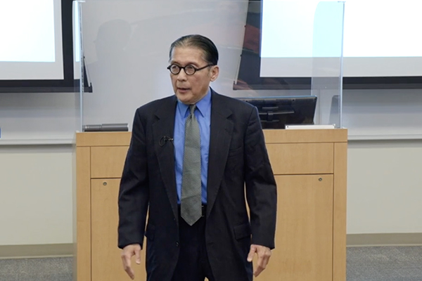 KC Ma speaks to a group at financial workshop