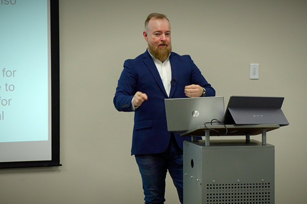 Rich Preston speaks to a group at financial workshop
