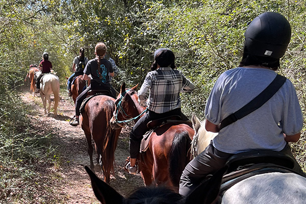 UWF Students riding horsebacks.