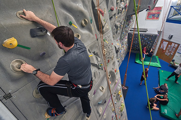 UWF Student climbing the climb wall.