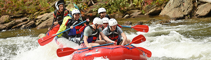 Students riding down water rapids.
