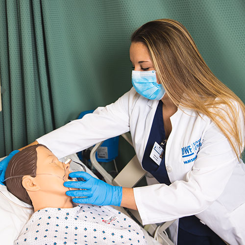 nursing student practicing giving oxygen to a dummy patient