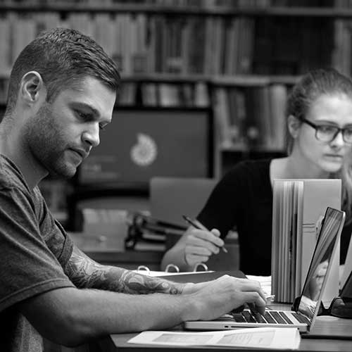 two students in the library studying