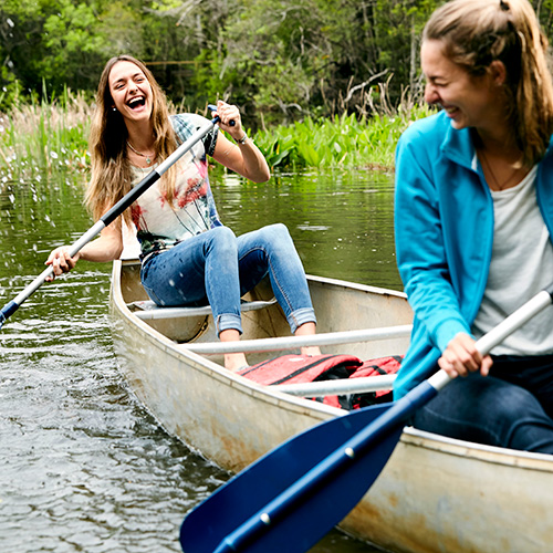 two uwf students in a canoe on thompson bayou on the pensacola campus