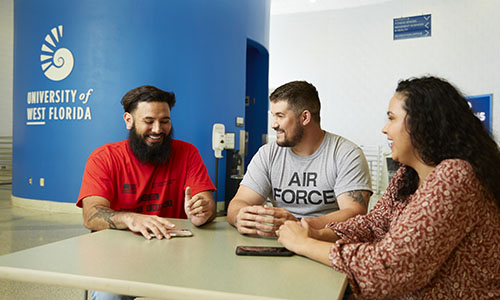 Veteran students chat at a table in the Health, Leisure, and Sports Facility.