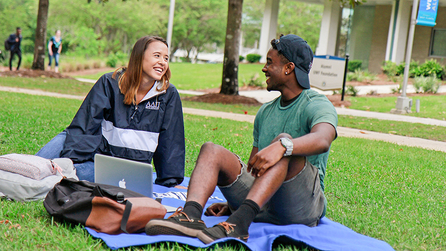 Students sitting on the lawn at UWF Pensacola campus