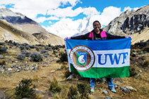 A student holds a UWF flag