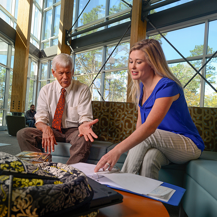 dr kimball advising a student in the cob atrium
