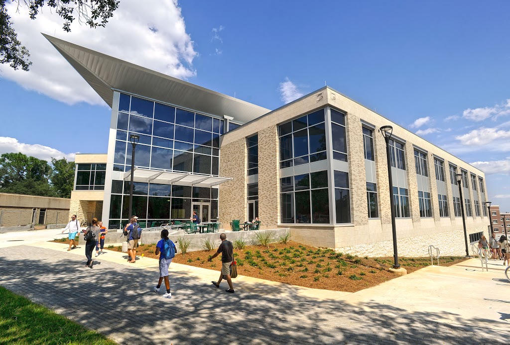 Students walking past Building 76A on the UWF Pensacola campus.