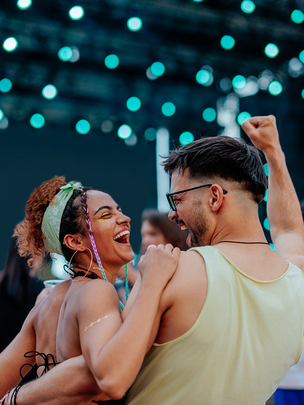 two young people enjoy a concert