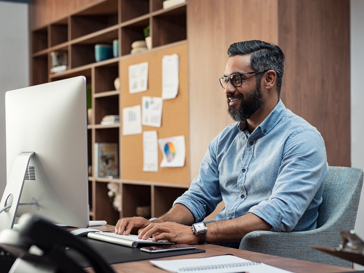 Data Scientist working at a desktop computer