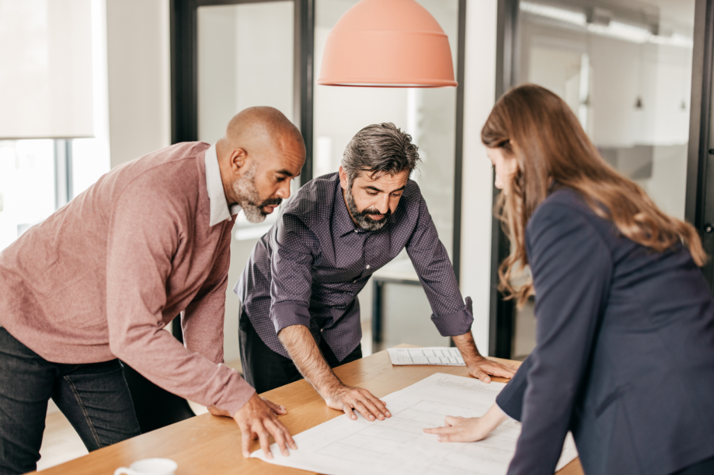 Businessmen and woman looking at a chart