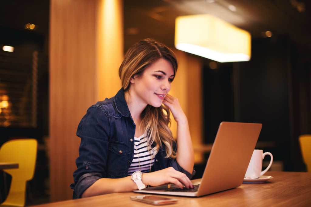 Woman sitting and using her laptop