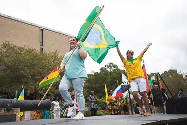 students carrying a Brazilian flag at the annual UWF Global Block Party 
