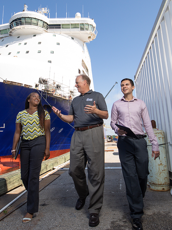 supply chain logistics management students walking through a ship port