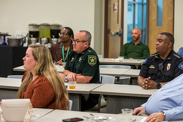 Students and police officers sitting in class.